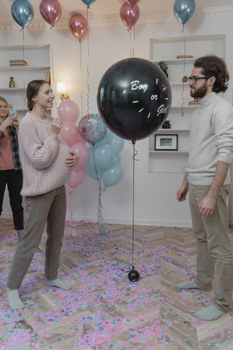 A Couple about to Pop a Balloon at a Gender Reveal Party